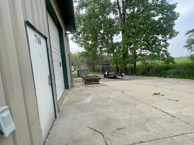 Rear door of unit 710 and the paved lot behind the building